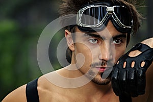 Man with motorcycle goggles and gloves