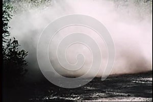 Man on motorcycle skidding off dirt road