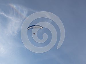 Man on motorized hang glider taken from the ground