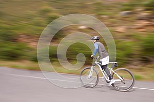 Man, mountain bike and cycling on road for nature adventure, speed or outdoor extreme sports. Male person or cyclist on