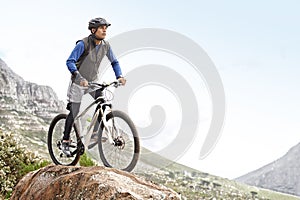 Man, mountain bike and off road cycling with mockup space on nature adventure or fitness in outdoor extreme sport. Male