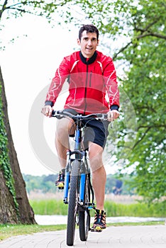 Man on mountain bike in the woods cycling