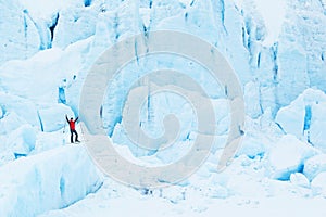 Man on a mountain climbing on large chunks of snow