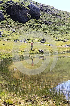 Man and a mountain reflected on a lake