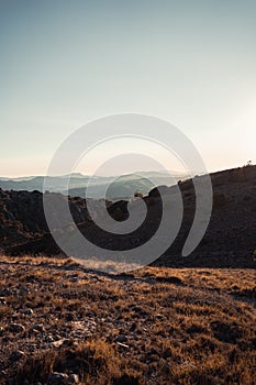 Man in the mountain at sunset. Guy practicing trekking