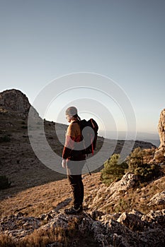 Man in the mountain at sunset. Guy practicing trekking