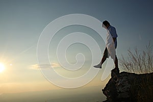 a man on a mountain top. Person on the rock. Sport and active life concept. Beauty world