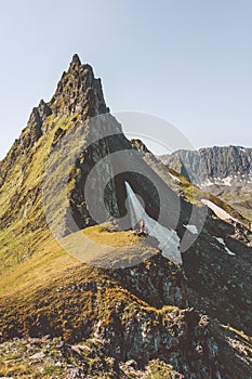 Man mountaineering alone standing on cliff edge