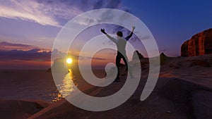 Man in the mountains against the background of dawn