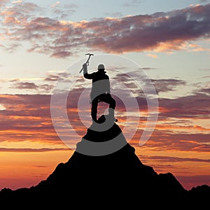 Man on mountains with ice axe in hand