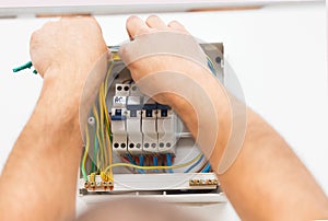 Man Mounting Electric Fuse