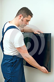 Man mounting TV.