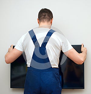 Man mounting TV.