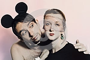 Man with mouse ears and woman in a veil