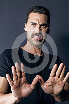 Man with moustache showing a disgusted facial expression