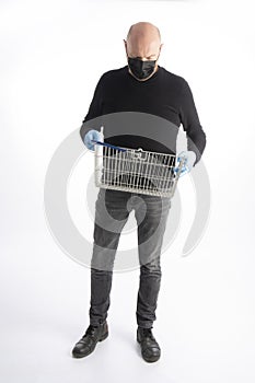 Man with mouth protection and hand gloves looking in his shopping basket, isolated on white background