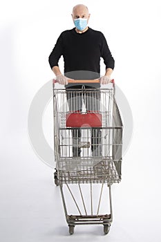 Man with mouth protection pushing a shopping cart, isolated on white background