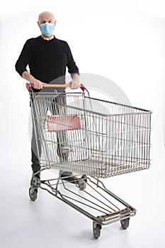 Man with mouth protection pushing a shopping cart, isolated on white background