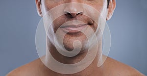 Man, mouth and smirk with face and lips for hygiene, jawline, and unhappy for treatment closeup. Grooming, mockup space
