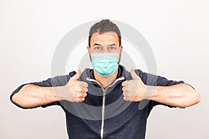 Man with a mouthguard with thumbs up isolated against white background