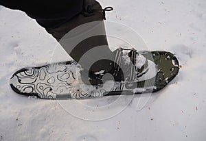 Man moves on snowshoes in the snow