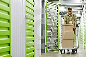 Man Moving Boxes in Self Storage Unit