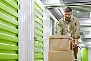 Man Moving Boxes in Storage Warehouse