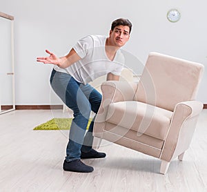 Man moving furniture at home