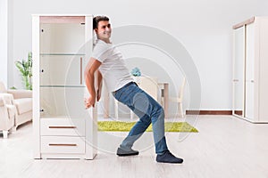 The man moving furniture at home