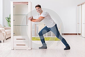 The man moving furniture at home