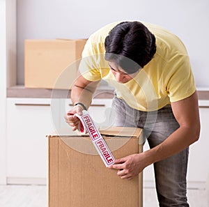 Man moving house and relocating with fragile items