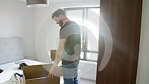 Man Moving Into New Home Talking On Mobile Phone