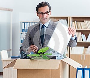 Man moving office with box and his belongings