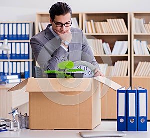 Man moving office with box and his belongings