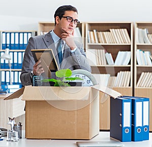 Man moving office with box and his belongings