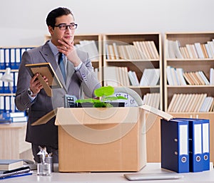 Man moving office with box and his belongings