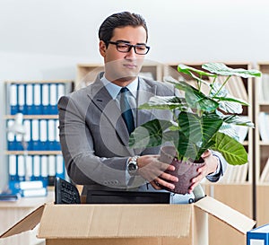 Man moving office with box and his belongings