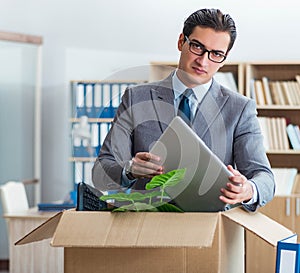 Man moving office with box and his belongings