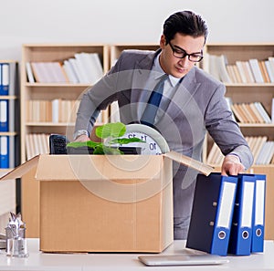 Man moving office with box and his belongings