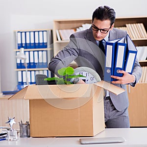 Man moving office with box and his belongings