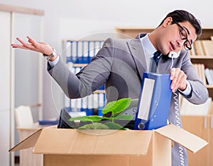 Man moving office with box and his belongings