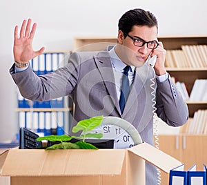 Man moving office with box and his belongings