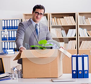 Man moving office with box and his belongings