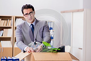 The man moving office with box and his belongings