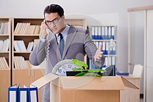 The man moving office with box and his belongings