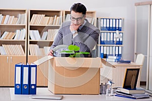 The man moving office with box and his belongings