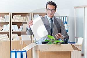 The man moving office with box and his belongings