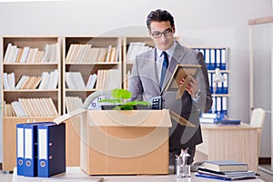 The man moving office with box and his belongings