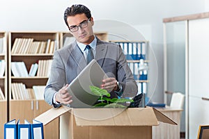 The man moving office with box and his belongings
