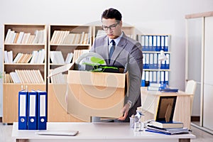 The man moving office with box and his belongings